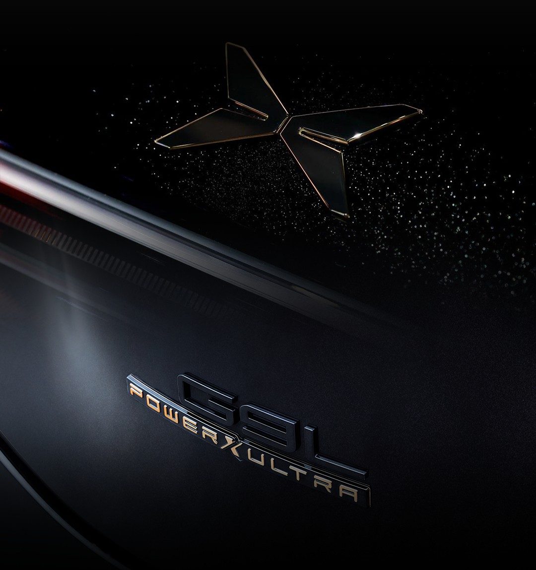 Close-up of the 24K gold XPENG badge and the black-gold G9L POWER X ULTRA tail badge