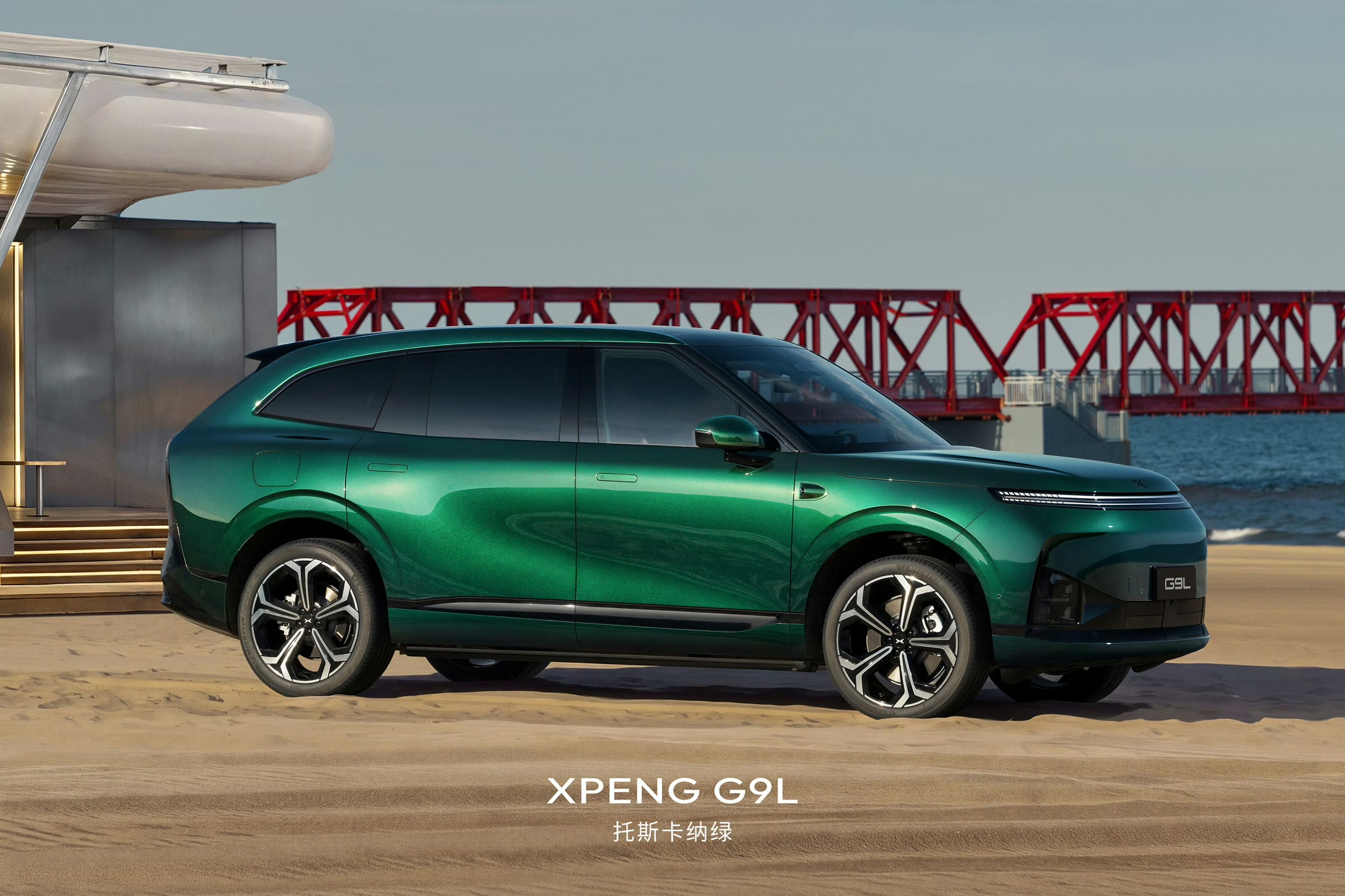 XPENG G9L sideprofil i Toscana-grøn på strand med rød mole