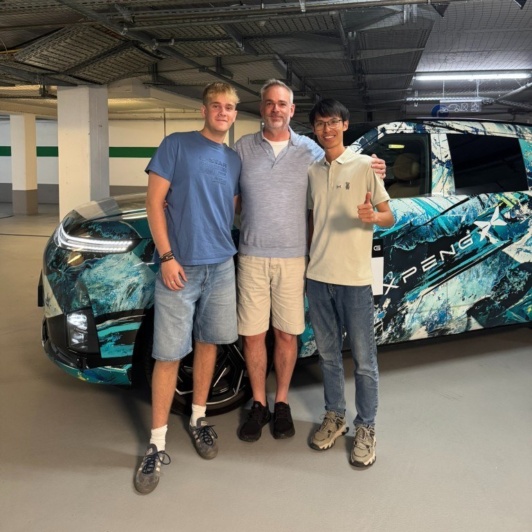 My son (left), me (centre) and Ye Zhiming, G9L Overseas Product Expert (right), beside a camouflaged G9L in Munich