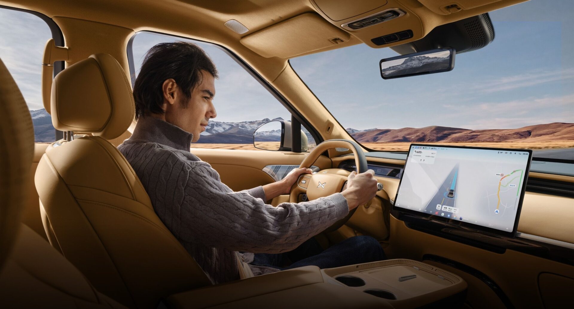 XPENG GX driver in tan cockpit with mountain view