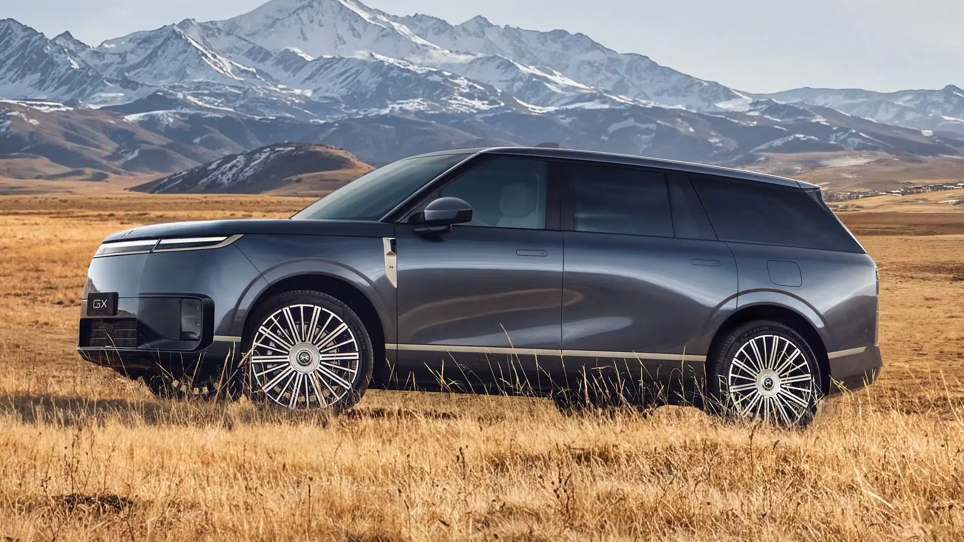 XPENG GX charcoal side profile in mountain grassland