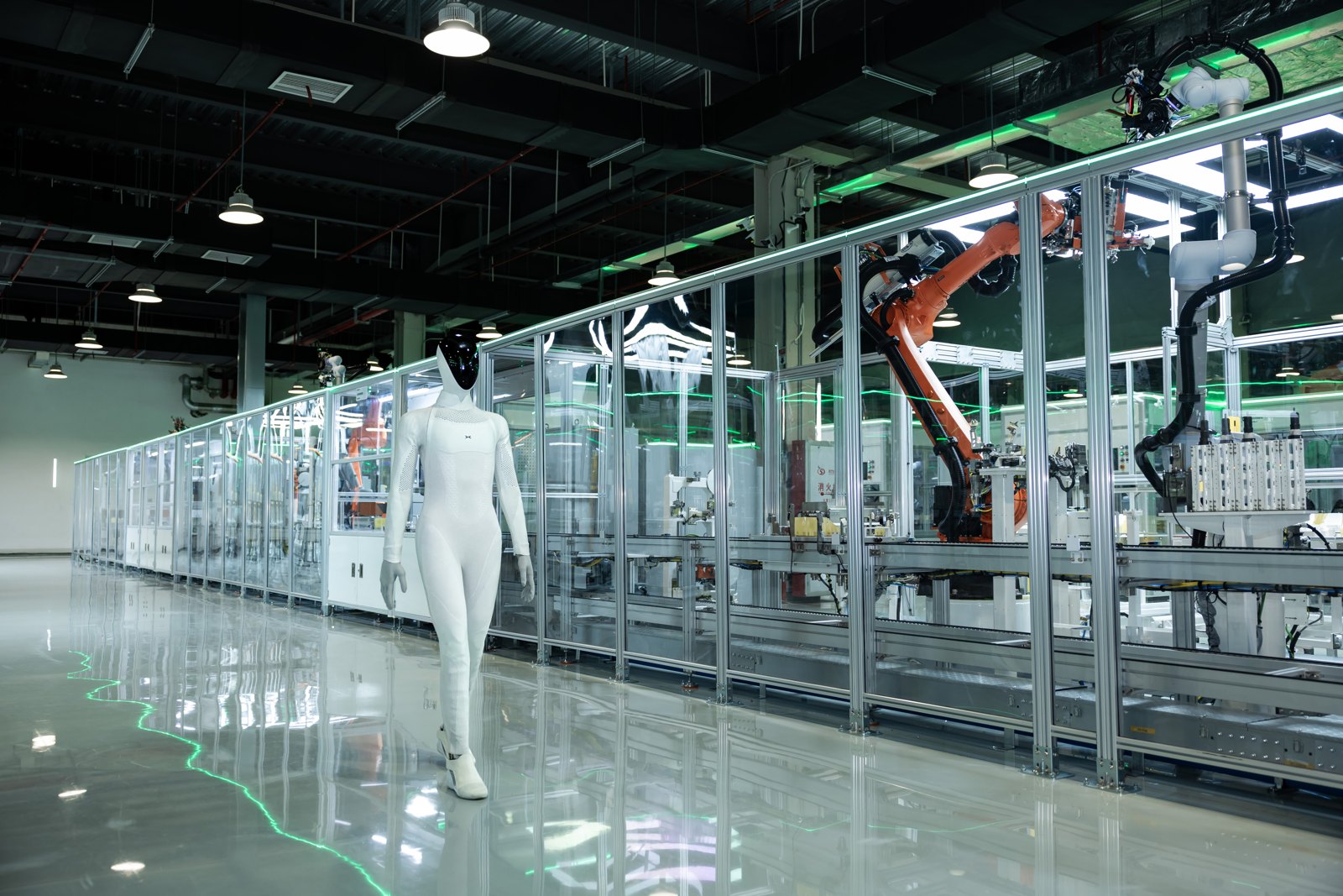 IRON beside the glass enclosure and industrial robots of the production line in Guangzhou