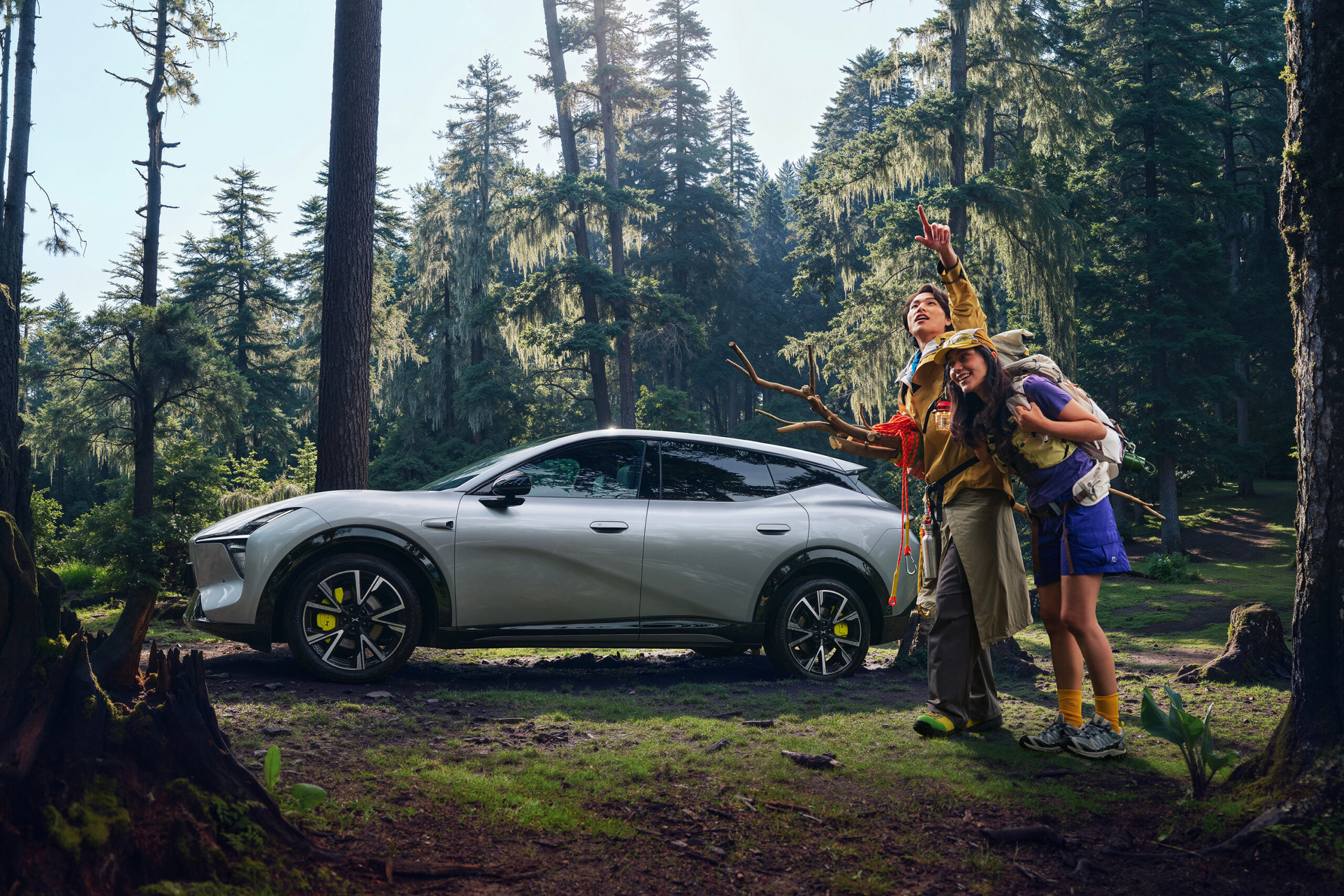 Silver L05 in side profile beside hikers in a forest