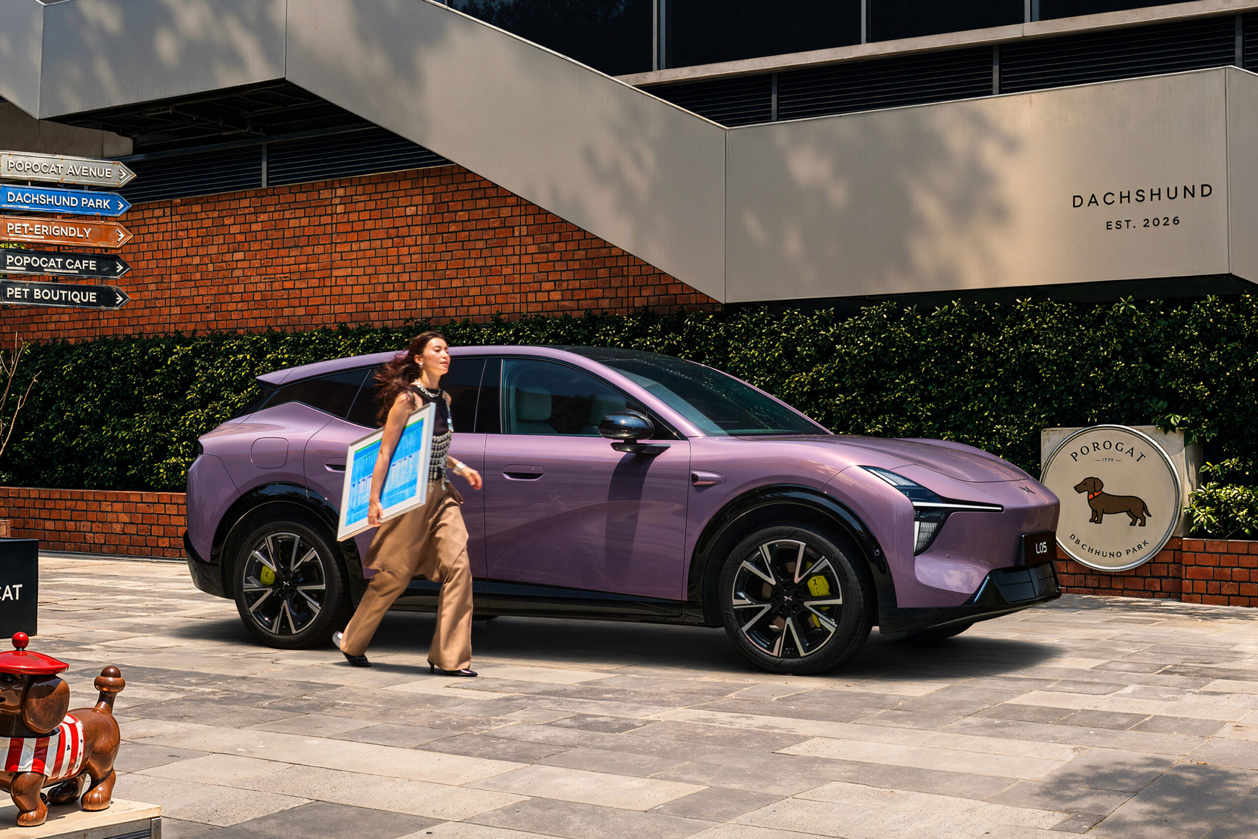 Purple L05 parked beside a pedestrian and a dog