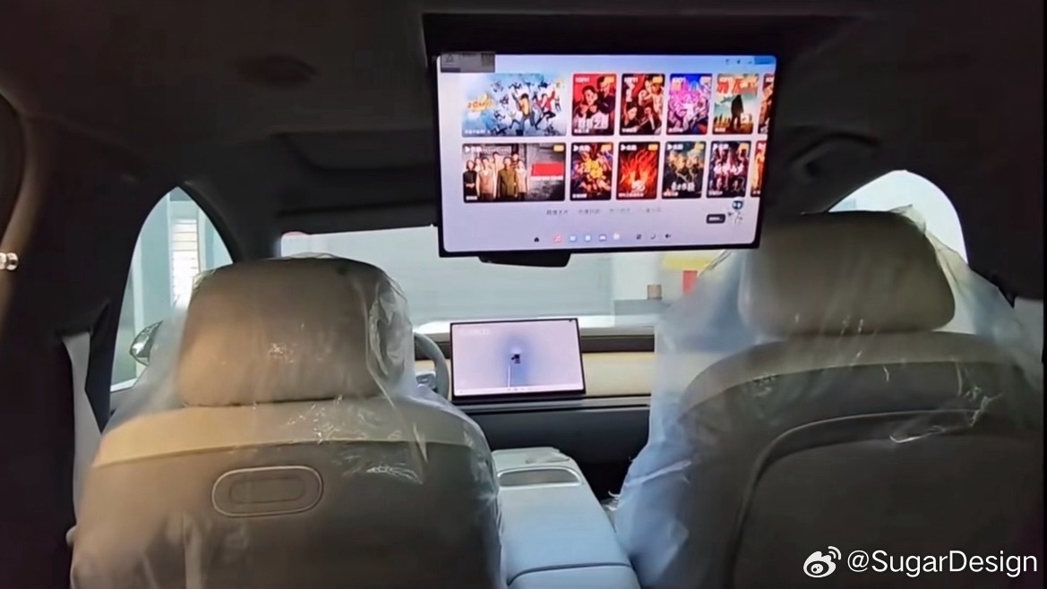 Ceiling screen folded down ahead of the rear seats