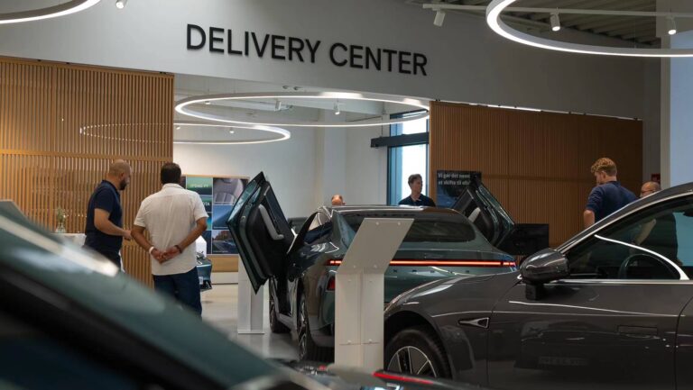 XPENG delivery centre with P7 cars and Danish signage on the wall
