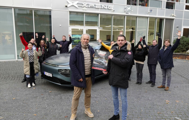 XPENG G9 on Norwegian plates outside a Norwegian XPENG store, staff celebrating