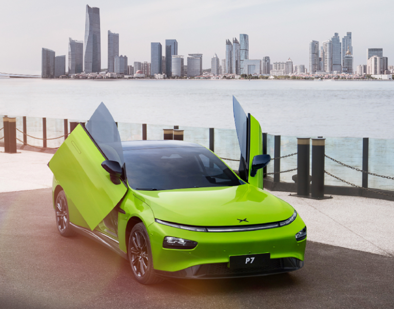 Lime green XPENG P7 Wing Edition with its scissor doors open on a waterfront