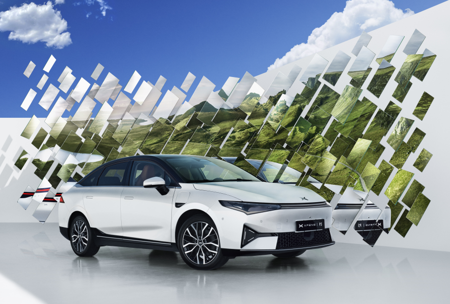 White XPENG P5 front three-quarter in a studio against a mirrored valley backdrop