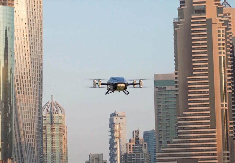 The XPENG X2 flying car hovering between Dubai Marina towers
