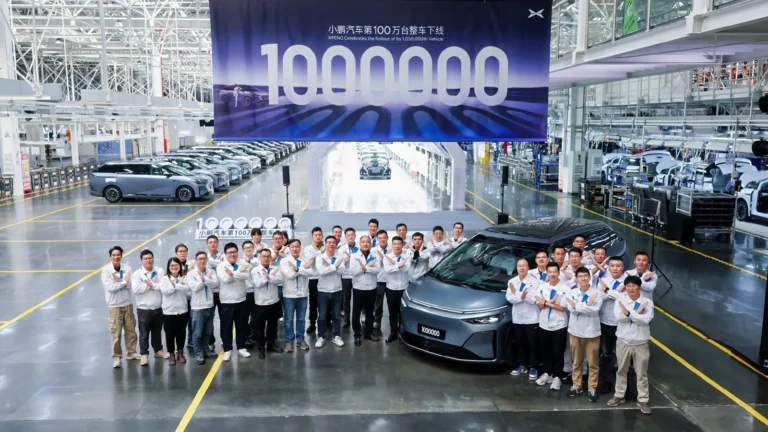 XPENG's production team in white jackets lined up in the Guangzhou plant beside a blue-grey X9 with the number plate 1000000, under a banner reading 1000000 and XPENG Celebrates the Rollout of Its 1,000,000th Vehicle