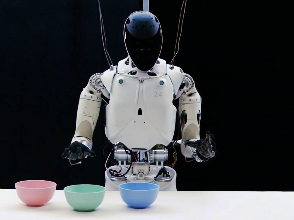 XPENG IRON humanoid robot in a test rig in front of three bowls on a white table