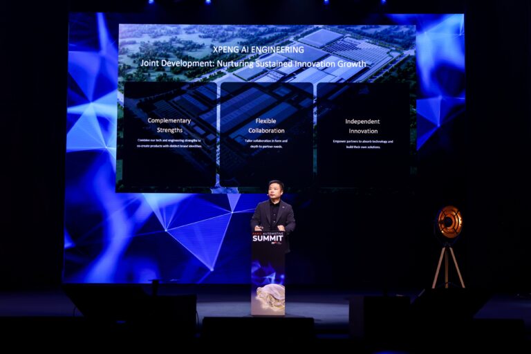 He Xiaopeng at the lectern of the Paris Automotive Summit in front of a slide headed XPENG AI Engineering with three panels: Complementary Strengths, Flexible Collaboration and Independent Innovation