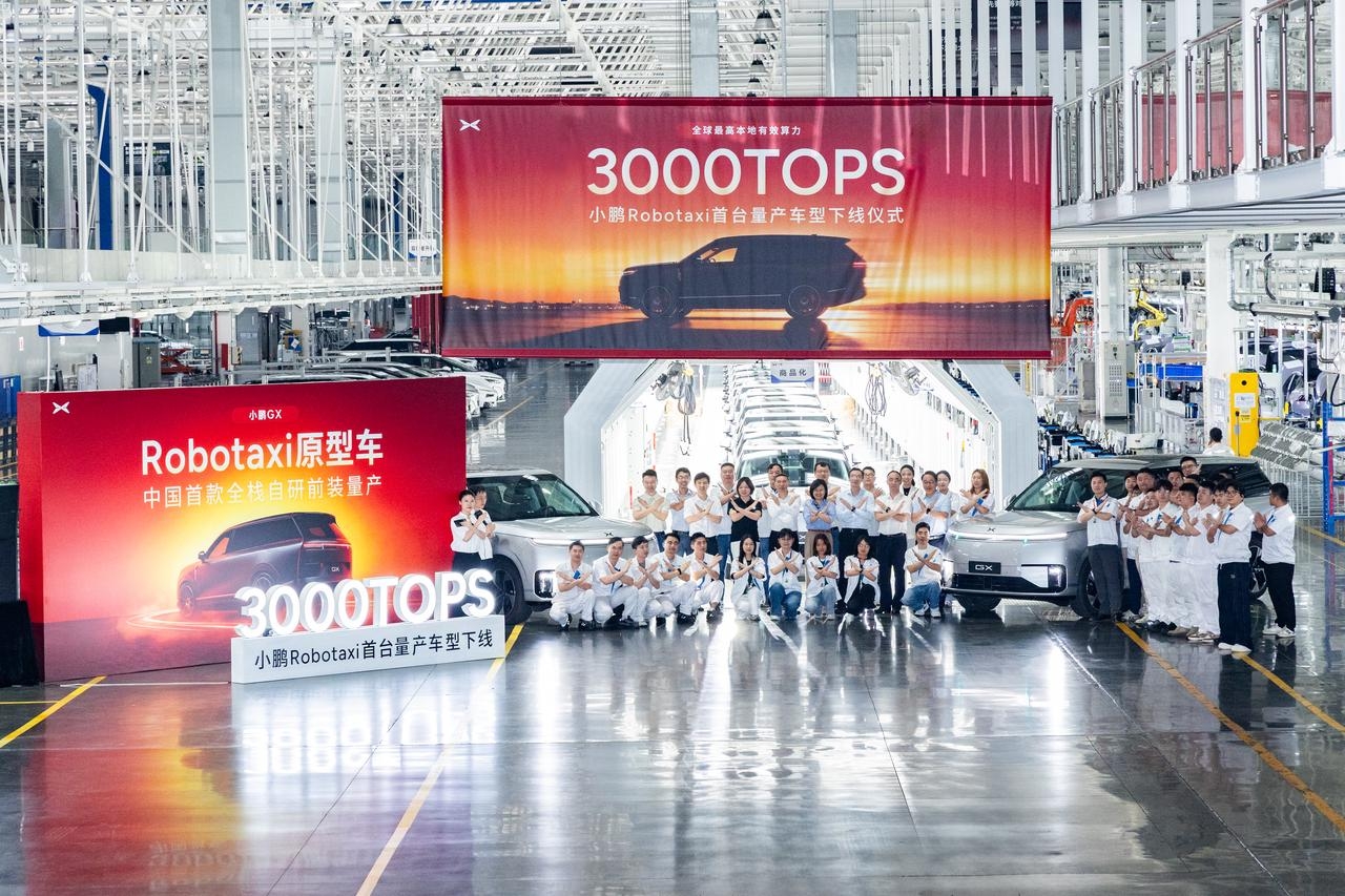 XPENG GX Robotaxi rollout - Guangzhou factory team with 3000 TOPS banner (May 2026)