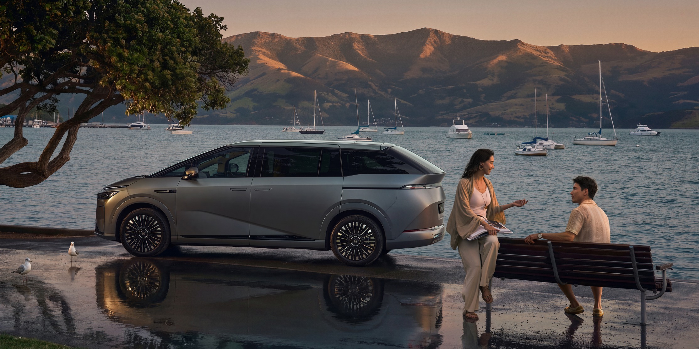 XPENG X9 side profile at a harbour at sunset